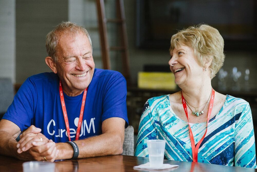 Two Grandparents laughing and smiling at Cure JM conference