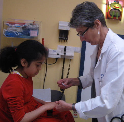 Medical professional works with a patient