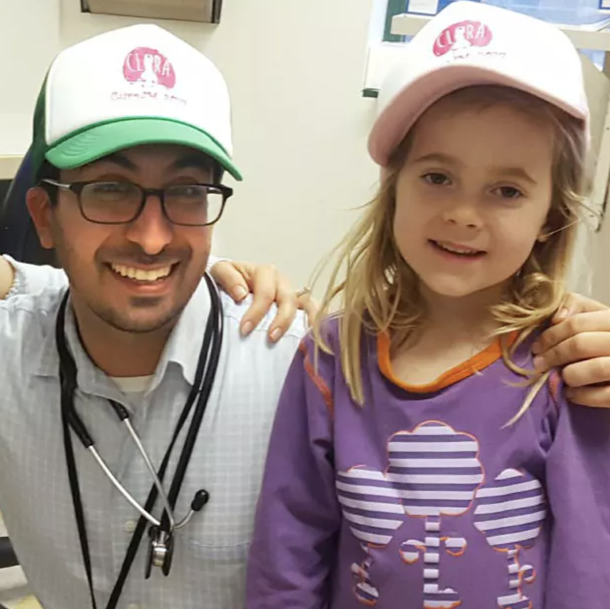 Doctor and young juvenile myositis patient.