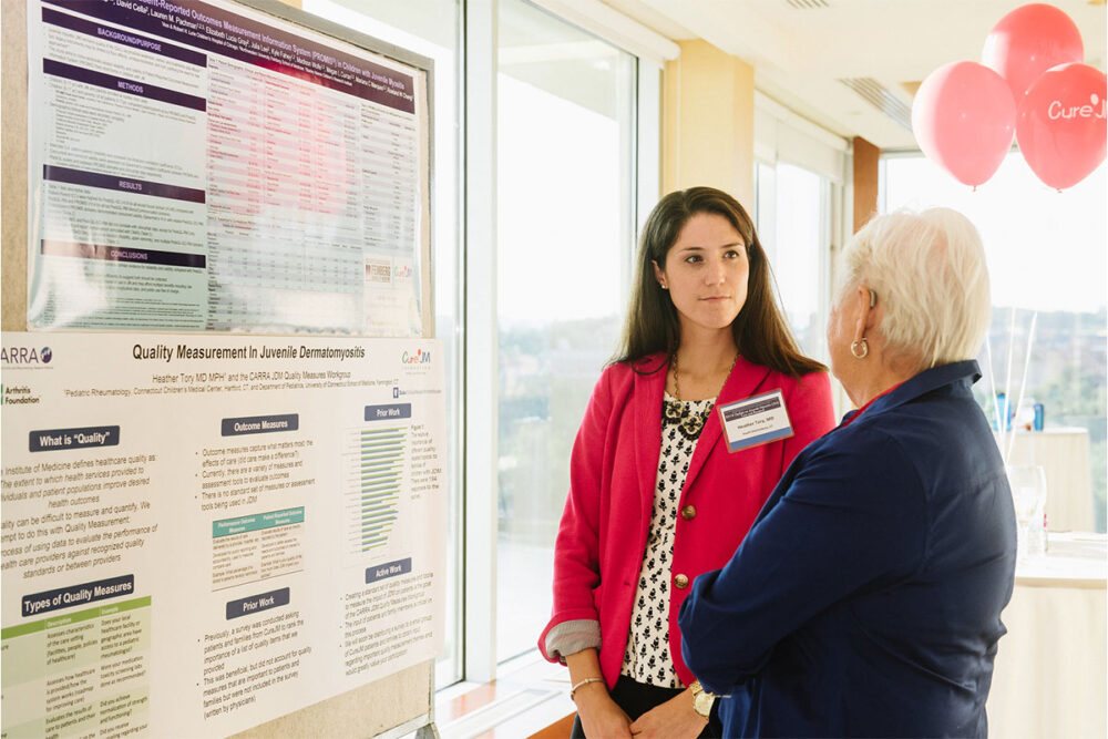 Two ladies discussing Juvenile Myositis Research