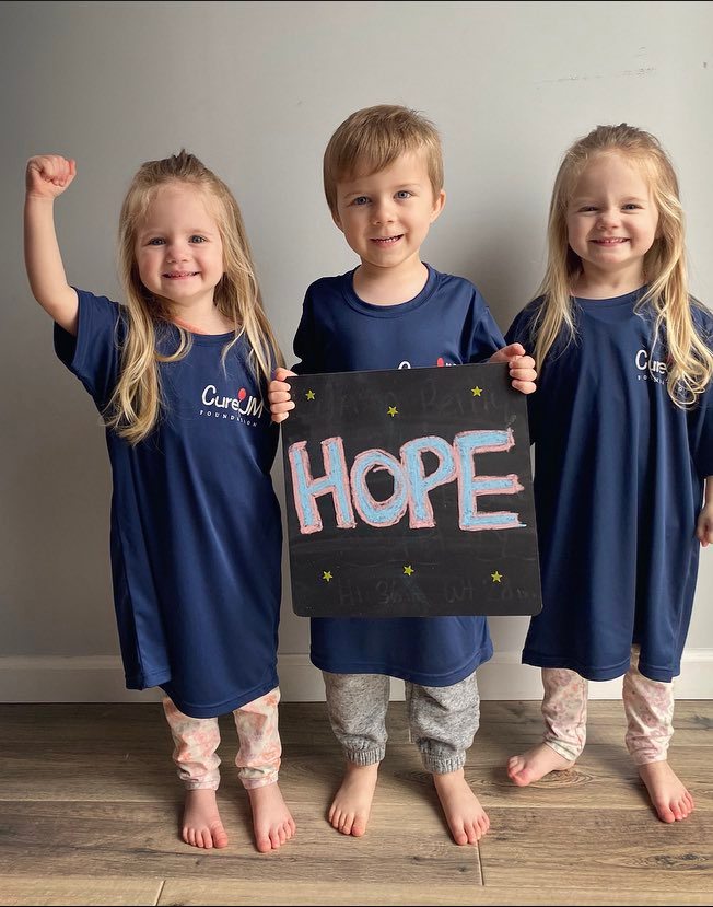 Three children with "Hope" sign